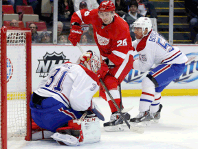 Detroit's Tomas Jurco, centre, is stopped by  Montreal goalie Carey Price as teammate Francis Bouillon helps to defend Thursday in Detroit. (AP Photo/Duane Burleson)