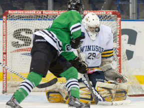 Windsor goaltender Parker Van Buskirk, right, stops a shot from Saskatchewan's Derek Hulak at the CIS University Cup in Saskatoon. (THE CANADIAN PRESS/Liam Richards)