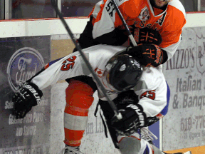 Essex's Dylan Solecki, top, collides with Dorchester's Gus Ford at the Essex Centre Sports Complex in Essex Friday, March 28, 2014. (TYLER BROWNBRIDGE/The Windsor Star)
