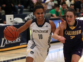 Windsor's Miah-Marie Langlois, left, drives to the basket against the Laurier Golden Hawks at the St. Denis Centre Saturday. (DAX MELMER/The Windsor Star)