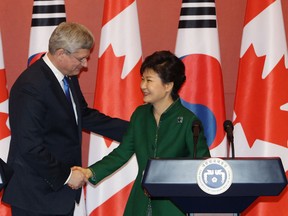 Canadian Prime Minister Stephen Harper shakes hands with South Korean President Park Geun-Hye during their joint press conference at presidential house on on March 11, 2014 in Seoul, South Korea. Harper and his South Korean counterpart announced that Canada and South Korea have reached a free-trade agreement, ending around nine years of on-off negotiations.  (Photo by Park Jin-Hee-Pool/Getty Images)