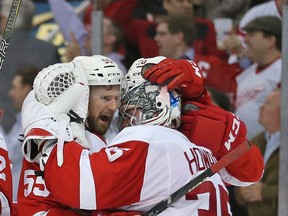Detroit's Niklas Kronwall, left, celebrates an overtime win with teammate Jimmy Howard against the Pittsburgh Penguins at Joe Louis Arena. (Photo by Leon Halip/Getty Images)