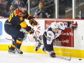 Erie's Quentin Maksimovich, left, upends Andrew Burns of the Windsor Spitfires earlier this year in Erie. (ANDY COLWELL/Erie Times News)