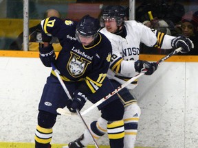 The University of Windsor's Richard Cameron, right, checks Lakehead's Nathan Bruyere at South Windsor Arena. (TYLER BROWNBRIDGE/The Windsor Star)