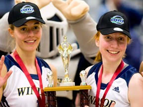 Windsor's Jessica Clemencon, left, and Emily Prevost hold up the OUA championship trophy after defeating  the Queen's Gaels 73-48 in the OUA final Saturday at the St. Denis Centre. (JOEL BOYCE/The Windsor Star)