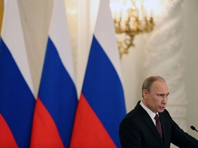 Russia's President Vladimir Putin addresses the Federation Council in Moscow's Kremlin on Tuesday, March 18, 2014. President Vladimir Putin defended Russia’s move to annex Crimea, saying that the rights of ethnic Russians have been abused by the Ukrainian government.  He pointed at the example of Kosovo’s independence bid supported by the West, and said that Crimea’s secession from Ukraine repeated Ukraine’s own secession from the Soviet Union in 1991. (AP Photo/Sergei Ilnitsky)