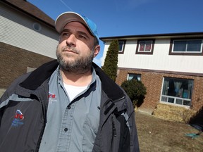 Joe Hebert is photographed  in front of his home in Windsor on Tuesday, March 25, 2014. Joe is upset that the electricity for the modest sized home topped $1000 last month.                      (TYLER BROWNBRIDGE/The Windsor Star)