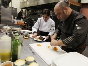 WINDSOR, ON.: MARCH 6, 2014 -- Visiting chef Francesco Straface works on a dish with assistant Sanaz Abdolahi (left) at La Rucola in Tecumseh on Thursday, March 6, 2014.                     (TYLER BROWNBRIDGE/The Windsor Star)