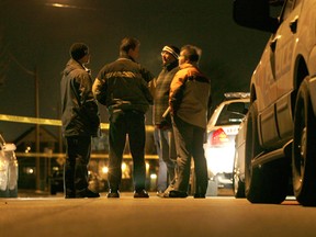 Windsor police detectives confer at the scene of a shooting in this 2008 file photo. (Jason Kryk / The Windsor Star)
