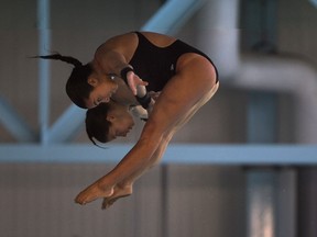 Rosaline Filion, 26, and Meaghan Benfeito, 25, both members of the Canadian National Diving team and 2012 Olympic bronze medalists, perform a tandem dive at the kick off countdown to the hosting of the Windsor leg of the FINA/NVC Diving World Series at the Windsor International Aquatic and Training Centre, Wednesday, March 26, 2014.  The event will take place May 30 to June 1, 2014.  (DAX MELMER/The Windsor Star)