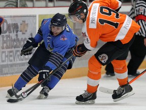 The Essex 73's Scott Bromley and the Amherstburg Admirals Chad Copeland battle for the puck at the Essex Centre Sports Complex in Essex on Tuesday, December 10, 2013.  (TYLER BROWNBRIDGE/The Windsor Star)