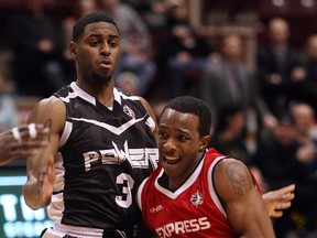 The Windsor Express' Stefan Bonneau drives to the net around the Mississauga Power's Ashton Smith at the WFCU Centre in Windsor on Tuesday, March 4, 2014. The Express defeated the Power 105-97.                     (TYLER BROWNBRIDGE/The Windsor Star)