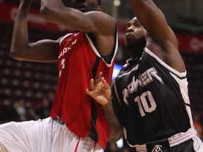 Express forward Chris Commons, left, battles Mississauga's Jushay Rockett at the WFCU Centre in Windsor on Wednesday, March 5, 2014. (TYLER BROWNBRIDGE/The Windsor Star)