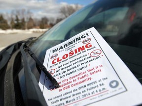 A flyer warning of unsafe fire protection when Fire Station 5 closes is left on the windshield of a vehicle parked at Corpus Christi Catholic Church in South Windsor, Sunday, March 23, 2014.  (DAX MELMER/The Windsor Star)