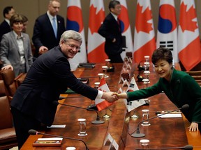 In this file photo, Canadian Prime Minister Stephen Harper, left, shakes hands with South Korean President Park Geun-Hye during their meeting at presidential house on March 11, 2014 in Seoul, South Korea. Harper and his South Korean counterpart announced that Canada and South Korea have reached a free trade agreement.  (Photo by Park Jin-Hee-Pool/Getty Images)