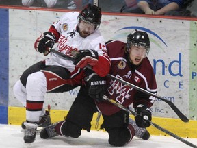 Leamington's David Dalby, left, and Chatham's Connor Annett collide Sunday, March 30, 2014, during a playoff game at the Leamington Kinsmen Recreation Complex. (DAN JANISSE/The Windsor Star)
