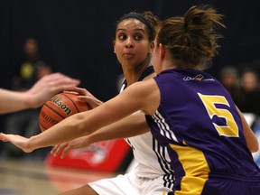 Windsor's Miah-Marie Langlois is guarded by Laurier's Nicole Morrison as she runs the offence as the Windsor Lancers host the Laurier Golden Hawks at the St. Denis Centre in the OUA women's basketball West final, Saturday, March 1, 2014.  Windsor defeated Laurier 86-58. (DAX MELMER/The Windsor Star)