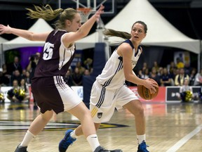 University of Windsor Lancers Kristine Lalonde protects the ball from Saint Mary’s Huskies in the CIS/SIC Women's Basketball Championship game at the St. Denis Centre in Windsor March 16, 2014. (JOEL BOYCE/The Windsor Star)