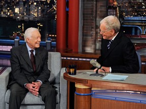 Former U.S. president Jimmy Carter, left, shares a chuckle with Late Show host David Letterman on March 24, 2014. (CBS / AP Photo)