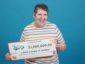 Windsor resident Louise Lavigne shows her cheque from the Lotto MAX draw of March 7. Image courtesy of the Ontario Lottery and Gaming Corporation at the Toronto prize centre on March 19, 2014. (Handout / The Windsor Star)