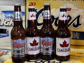 Coors Light and Molson Canadian bottles of beer, (Canadian Press files)