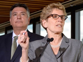 Ontario Premier Kathleen Wynne and Finance Minister Charles Sousa hold a news conference in Toronto, Monday, March 17, 2014. (Frank Gunn/The Canadian Press)