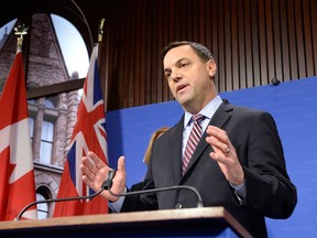 Ontario Conservative Leader Tim Hudak talks to media at Queen's Park in Toronto on Thursday, March 27, 2014. Hudak says Premier Kathleen Wynne is linked to new allegations that a staffer with former premier Dalton McGuinty gave an outside tech expert access to government computers. THE CANADIAN PRESS/Frank Gunn