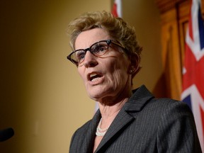 Ontario Premier Kathleen Wynnes talks to media outside her office at Queen's Park in Toronto on Thursday, March 27, 2014. THE CANADIAN PRESS/Frank Gunn