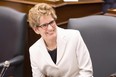 In this file photo, Premier Kathleen Wynne was all smiles during the recent throne speech, and why not? She's going to raise your utility rates 42 per cent over the next five years. THE CANADIAN PRESS/Chris Young