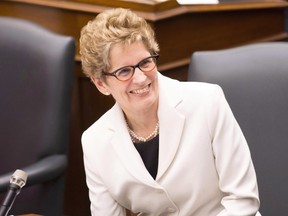 In this file photo, Premier Kathleen Wynne was all smiles during the recent throne speech, and why not? She's going to raise your utility rates 42 per cent over the next five years. THE CANADIAN PRESS/Chris Young