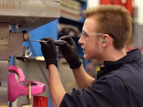 Shawn Boycott, an 18-year-old W.F. Herman Secondary School student, works on a mold during his OYAP placement at Reko International Group Inc. March 21, 2014. (Richard Riosa/The Windsor Star)