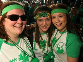 From left, Gillian Romanek, 26, Jen Rettig, 25, and Jessie O'Connor, 21 celebrate St. Patrick's Day a day early at the Rock Bottom Bar and Grill in Olde Sandwich Towne, Sunday, March 16, 2014.  (DAX MELMER/The Windsor Star)