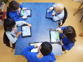 Young students work with iPads on March 3, 2014 in Stockholm. (JONATHAN NACKSTRAND/AFP/Getty Images)