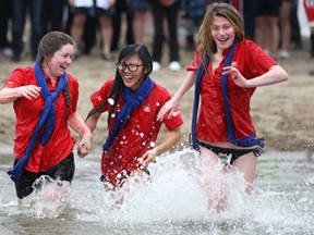 From left, Rachel Nicholson, Suki Gaffan, and Sarah Jones, representing Home Hardware, participate in The Polar Bear Dip at Cedar Island Beach in Kingsville, Saturday, March 22, 2014.  Funds raised from the event go to ChildCan and Access County Community Support Services.  (DAX MELMER/The Windsor Star)