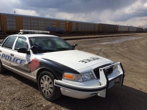 A Windsor police cruiser sits in the rail yard near Caron Avenue where a human hand was discovered on March 25, 2014. (Dan Janisse / The Windsor Star)