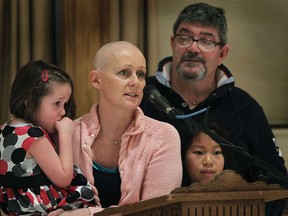 Amanda Ryall speaks during a pasta luncheon fundraiser, Sunday, March 30, 2014, at the Ciociaro Club in Windsor, Ont. Her husband Francis who is also fighting cancer looks on with daughters Kiera, 5, (L) and Molly, 9, during the event. (DAN JANISSE/The Windsor Star)