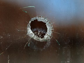 A bullet hole in a house window in the 200 block of Belleview Avenue in Windsor, Ont. on March 24, 2014. (Dan Janisse / The Windsor Star)