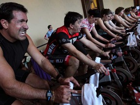 John Sciacca, left, takes part in the 7th Annual Spinergize for Hospice at Caesars Windsor, Saturday, March 22, 2014.  (DAX MELMER/The Windsor Star)