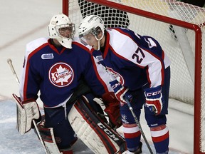 The Windsor Spitfires Dalen Kuchmey and Eric Diodati react to a goal scored by the London Knights at the WFCU Centre in Windsor on Tuesday, March 25, 2014.                       (TYLER BROWNBRIDGE/The Windsor Star)