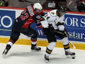 The Windsor Spitfires Sam Povorozniouk battles along the boards for the puck with the London Knights Gemel Smith at the WFCU Centre in Windsor on Thursday, March 27, 2014.                        (TYLER BROWNBRIDGE/The Windsor Star)