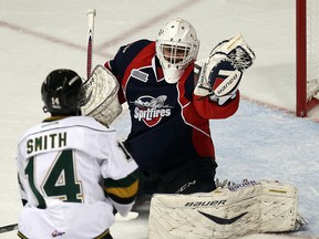 The Windsor Spitfires Alex Fontinos makes a glove save in front of the London Knights Gemel Smith at the WFCU Centre in Windsor on Thursday, March 27, 2014.                        (TYLER BROWNBRIDGE/The Windsor Star)