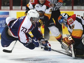 Windsor's Remy Giftopoulos flies through the air for one last shot in the final minute as the Windsor Spitfires host the Erie Otters at the WFCU Centre, Thursday, March 13, 2014.  Erie defeated Windsor 3-2.  (DAX MELMER/The Windsor Star)