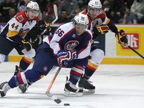Windsor's Josh Ho-Sang battles to bring the puck up the ice with Erie's Troy Donnay as the Windsor Spitfires host the Erie Otters at the WFCU Centre, Thursday, March 13, 2014.  Erie defeated Windsor 3-2.  (DAX MELMER/The Windsor Star)