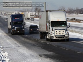 Transport trucks travel on icy roads in the Lakeshore area on March 13, 2014. (Nick Brancaccio / The Windsor Star)