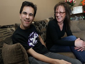 Dalton Murray and his mother Helen Murray are photographed in their Windsor home on Thursday, March 21, 2014. Dalton has cerebral palsy and needs a wheelchair to get around. His mom Helen has been lifting him up stairs and into her van but he's getting to big. Friends have organized a April 13 fundraiser because the family needs a new van so Dalton can get around.                     (TYLER BROWNBRIDGE/The Windsor Star)