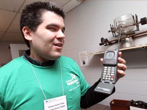 Andrew Dowie, chair of the Windsor Essex chapter for Professional Engineers Ontario, talks about an early generation cellphone at A Wireless World - How We've Re-engineered the Way We Communicate, at Canada South Science City, Saturday, March 29, 2014.   (DAX MELMER/The Windsor Star)