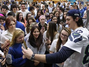 Super Bowl champion Luke Willson is surrounded by students during his visit to Villanova high school Thursday, March 6, 2014. Willson graduated from the LaSalle, Ont. school six years ago. (DAN JANISSE/Windsor Star)