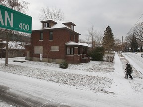 One of many dilapidated homes along Indian Road in Windsor is shown last December in the shadow of the Ambassador Bridge. The homes were purchased by the bridge company. (DAN JANISSE / Windsor Star files)