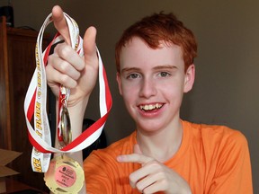 Accomplished runner Eric Coffey with some of his many medals. Coffey's love of running helps him cope with his epilepsy. (NICK BRANCACCIO / The Windsor Star)