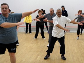 Mike Coffin, left, John Chhim and Evelyn McLeod, right, lead a group of their peers at Windsor Squash and Fitness during rehabilitation class for local residents moving ahead from colon, rectal and breast cancers. (NICK BRANCACCIO / The Windsor Star)